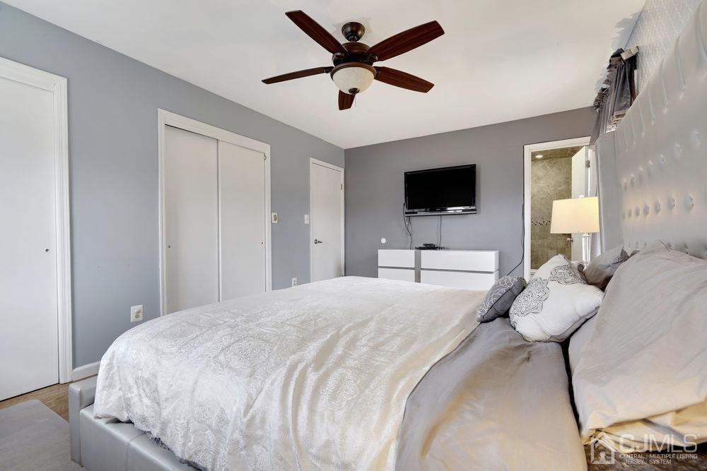 46 Brookside Road Edison, NJ 08817 - Photo 24 of 38 a bedroom with a bed and a flat tv screen on the dresser