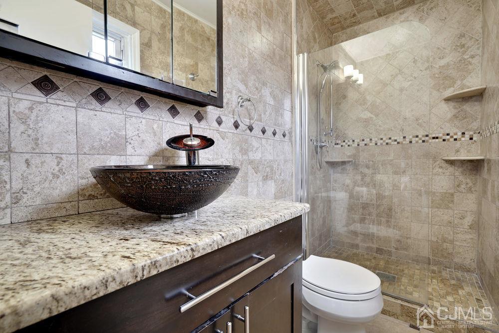 46 Brookside Road Edison, NJ 08817 - Photo 25 of 38 a bathroom with a granite countertop sink and a toilet