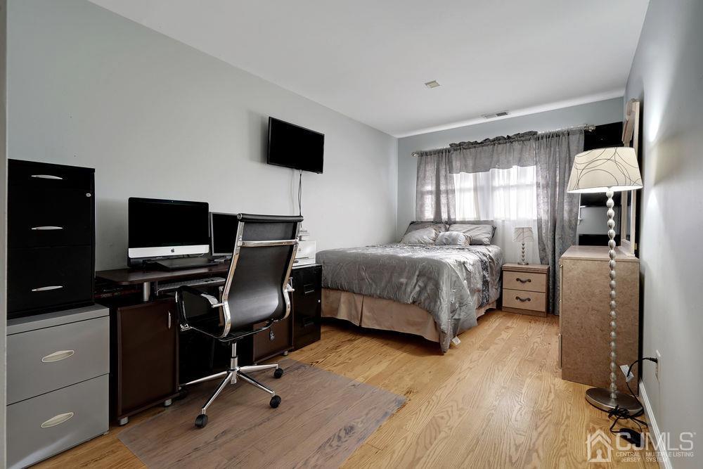 46 Brookside Road Edison, NJ 08817 - Photo 29 of 38 a bedroom with a bed flat screen tv and windows