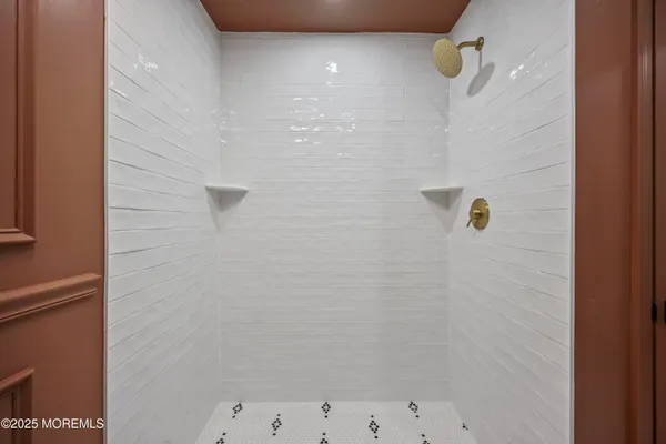 a spacious bathroom with a granite countertop sink a mirror and a shower
