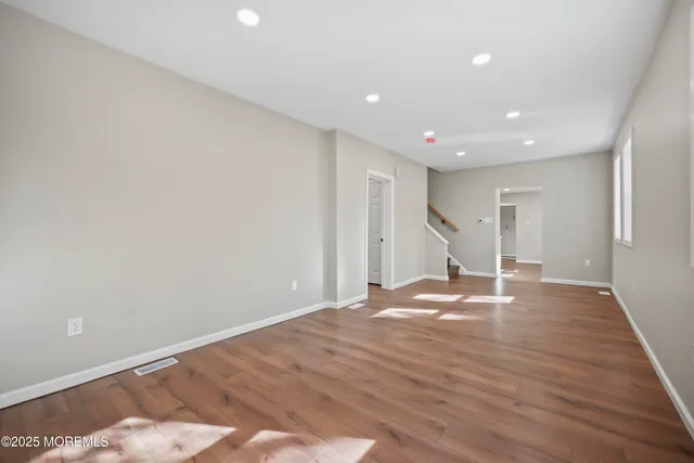 a spacious bathroom with a granite countertop sink a mirror and a shower