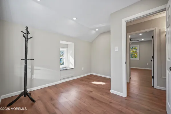a dining room with furniture and wooden floor