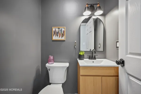 a bathroom with a toilet sink and mirror