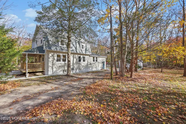 a large kitchen with stainless steel appliances granite countertop a stove a sink a refrigerator and a microwave