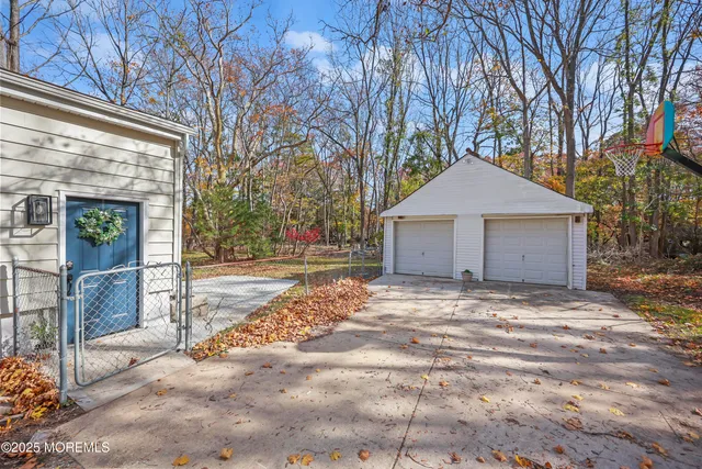 a kitchen with stainless steel appliances granite countertop a stove top oven a sink dishwasher a dining table and chairs with wooden floor