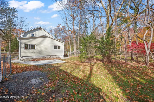 a kitchen with stainless steel appliances granite countertop a stove top oven a sink dishwasher a refrigerator and a microwave oven with wooden floor