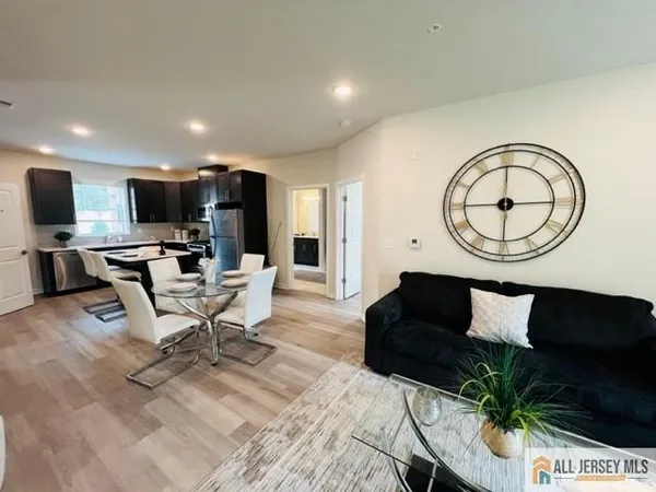 a living room with furniture a flat screen tv and a large window