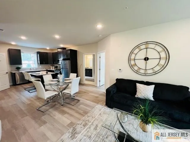 a living room with furniture a flat screen tv and a large window