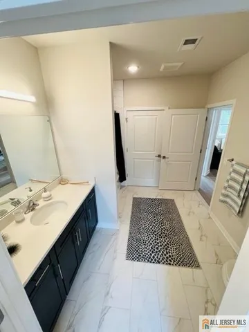 a bathroom with a double vanity sink and mirror