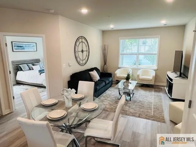 a view of a dining room with furniture a rug and wooden floor