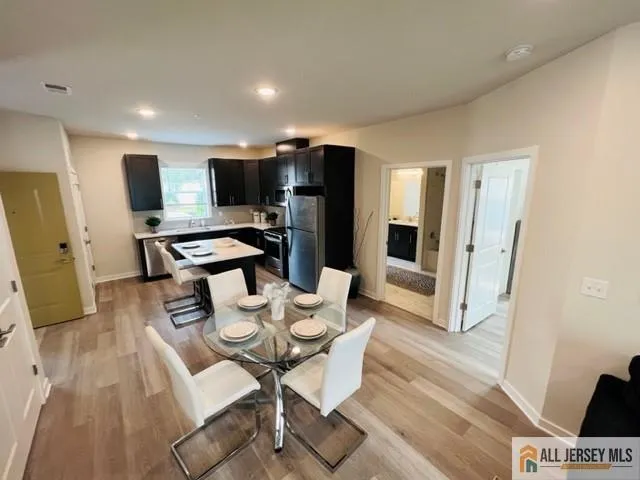 a kitchen with stainless steel appliances granite countertop a refrigerator stove microwave and sink