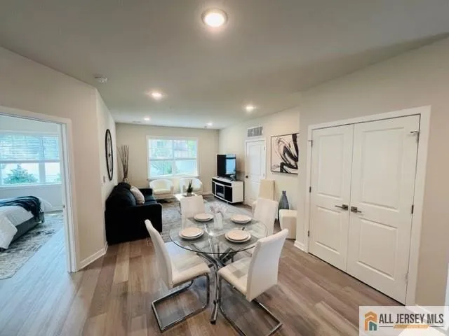 a kitchen with stainless steel appliances granite countertop a refrigerator a sink a stove a microwave a dining table and chairs