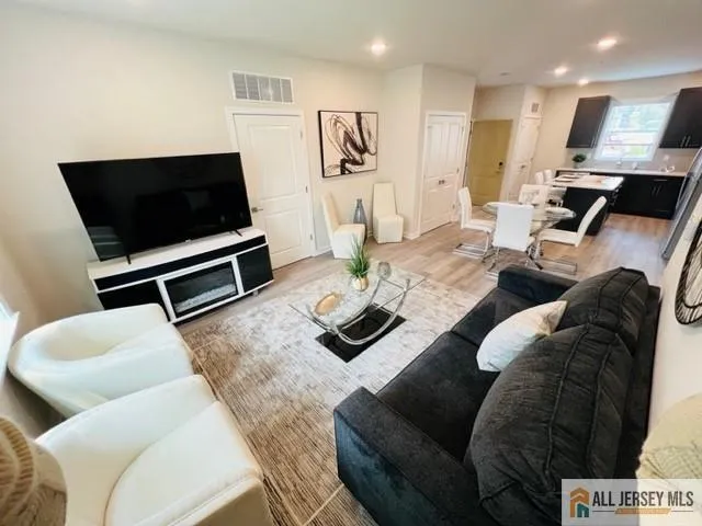a living room with furniture and a flat screen tv