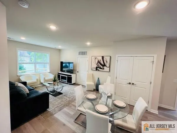 a living room with furniture and a wooden floor