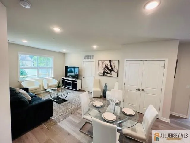 a living room with furniture and a wooden floor