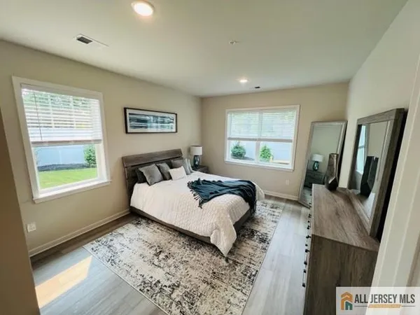 a bed room with a bed window and dresser