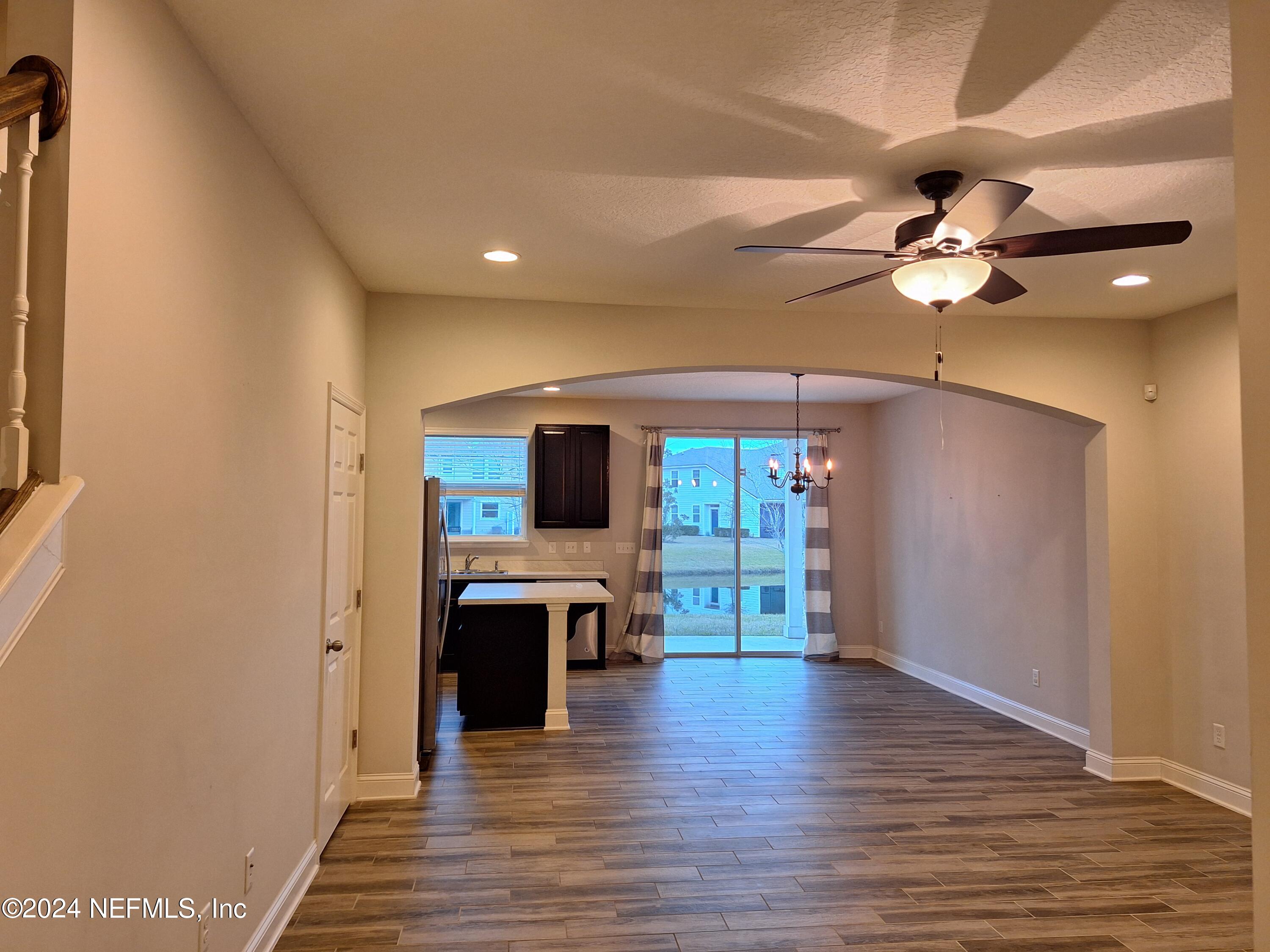 182 Nelson Lane St. Johns, FL 32259 - Photo 1 of 32 a view of a livingroom with a flat screen tv wooden floor and a ceiling fan