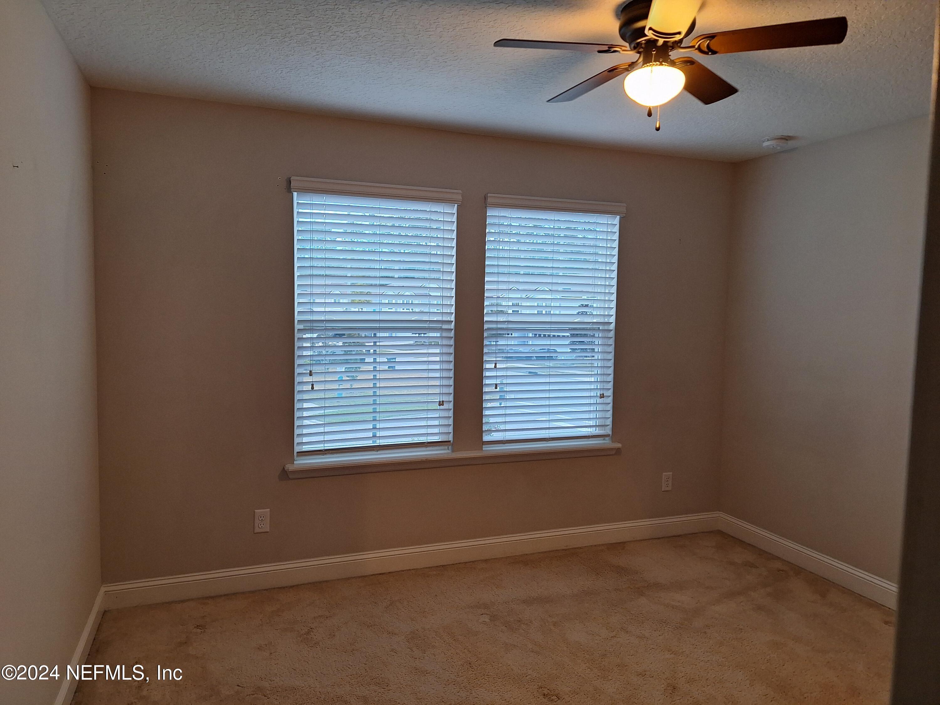 182 Nelson Lane St. Johns, FL 32259 - Photo 12 of 32 an empty room with a window and a fan