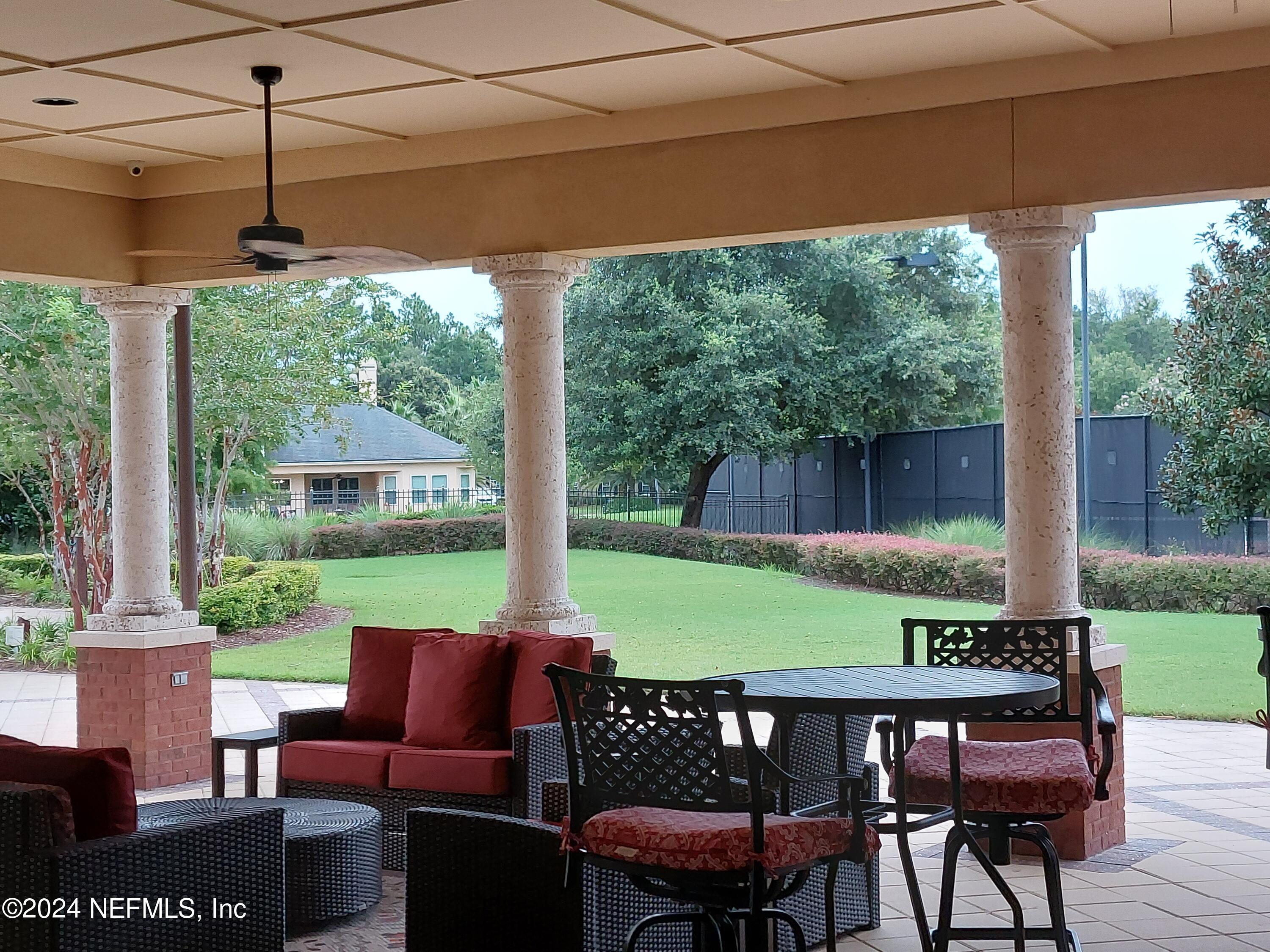 182 Nelson Lane St. Johns, FL 32259 - Photo 26 of 32 a view of a patio with a table chairs and a backyard