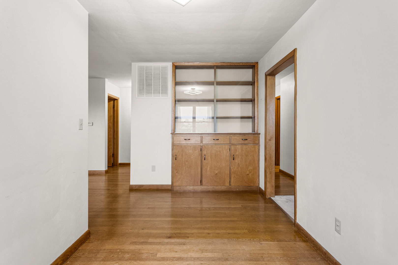 904 West Kirby Avenue Champaign, IL 61821 - Photo 17 of 46 a view of empty room with wooden floor and cabinet