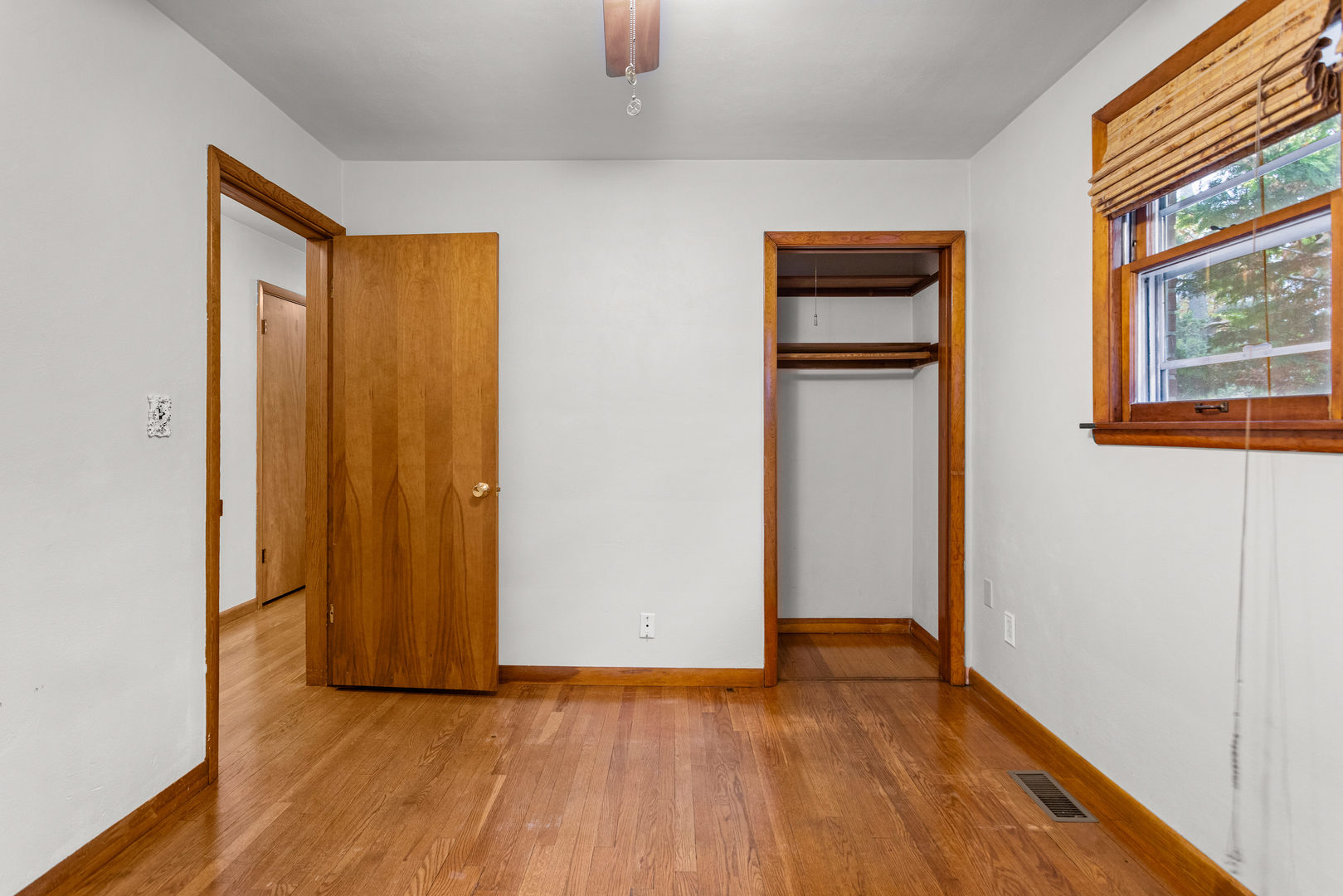 904 West Kirby Avenue Champaign, IL 61821 - Photo 23 of 46 a view of an empty room with wooden floor and a window