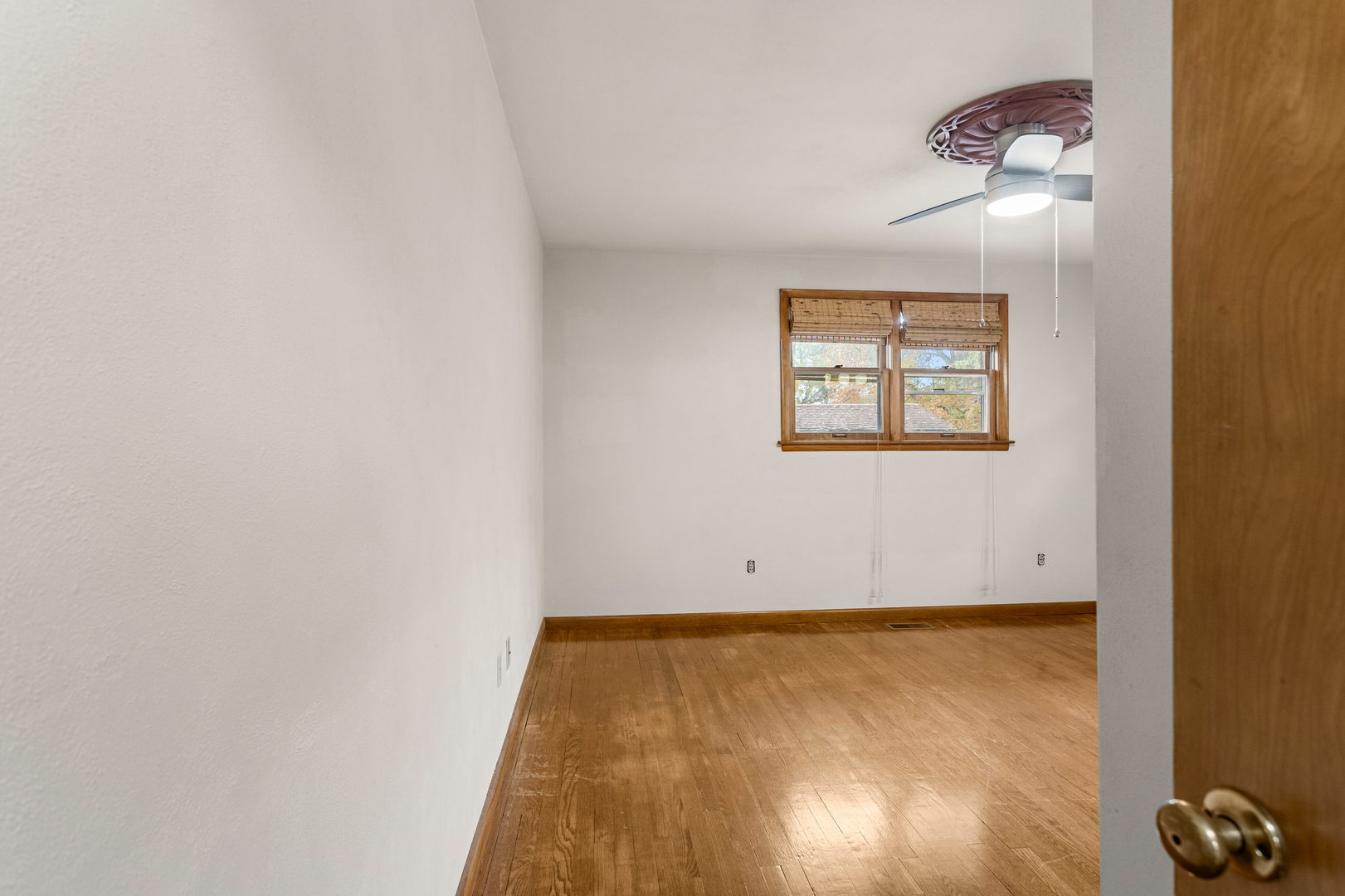 904 West Kirby Avenue Champaign, IL 61821 - Photo 24 of 46 an empty room with a ceiling fan and wooden floor