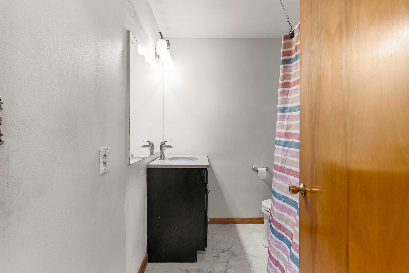 904 West Kirby Avenue Champaign, IL 61821 - Photo 27 of 46 a bathroom with a sink and mirror