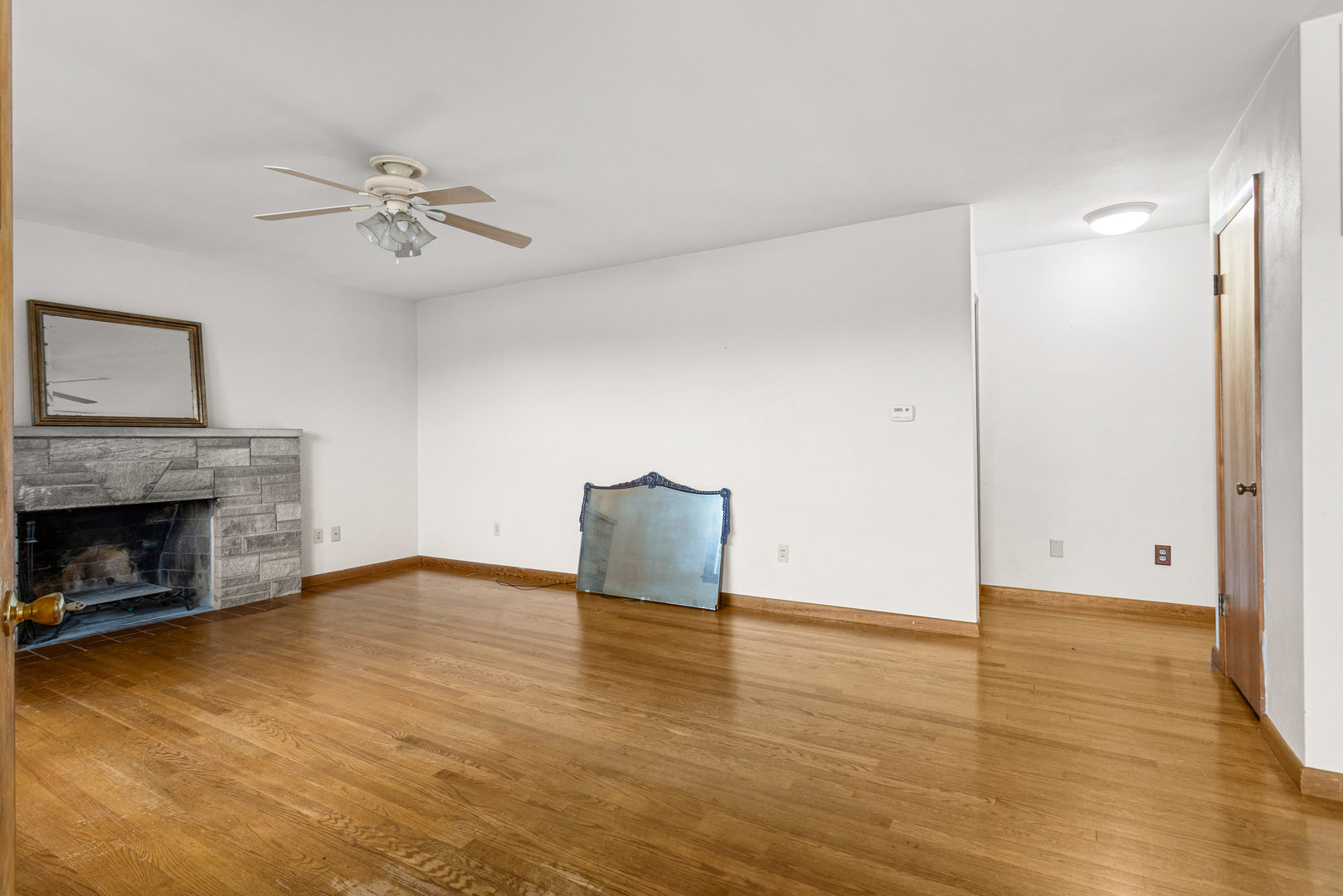 904 West Kirby Avenue Champaign, IL 61821 - Photo 4 of 46 a view of empty room with wooden floor and fireplace
