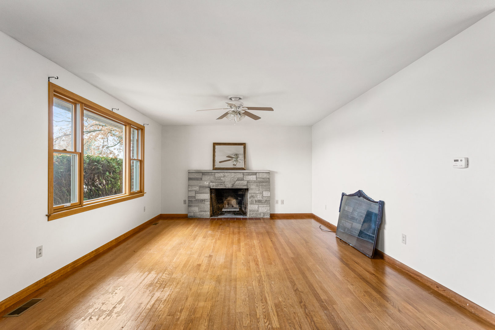 904 West Kirby Avenue Champaign, IL 61821 - Photo 5 of 46 a view of an empty room with wooden floor and a window