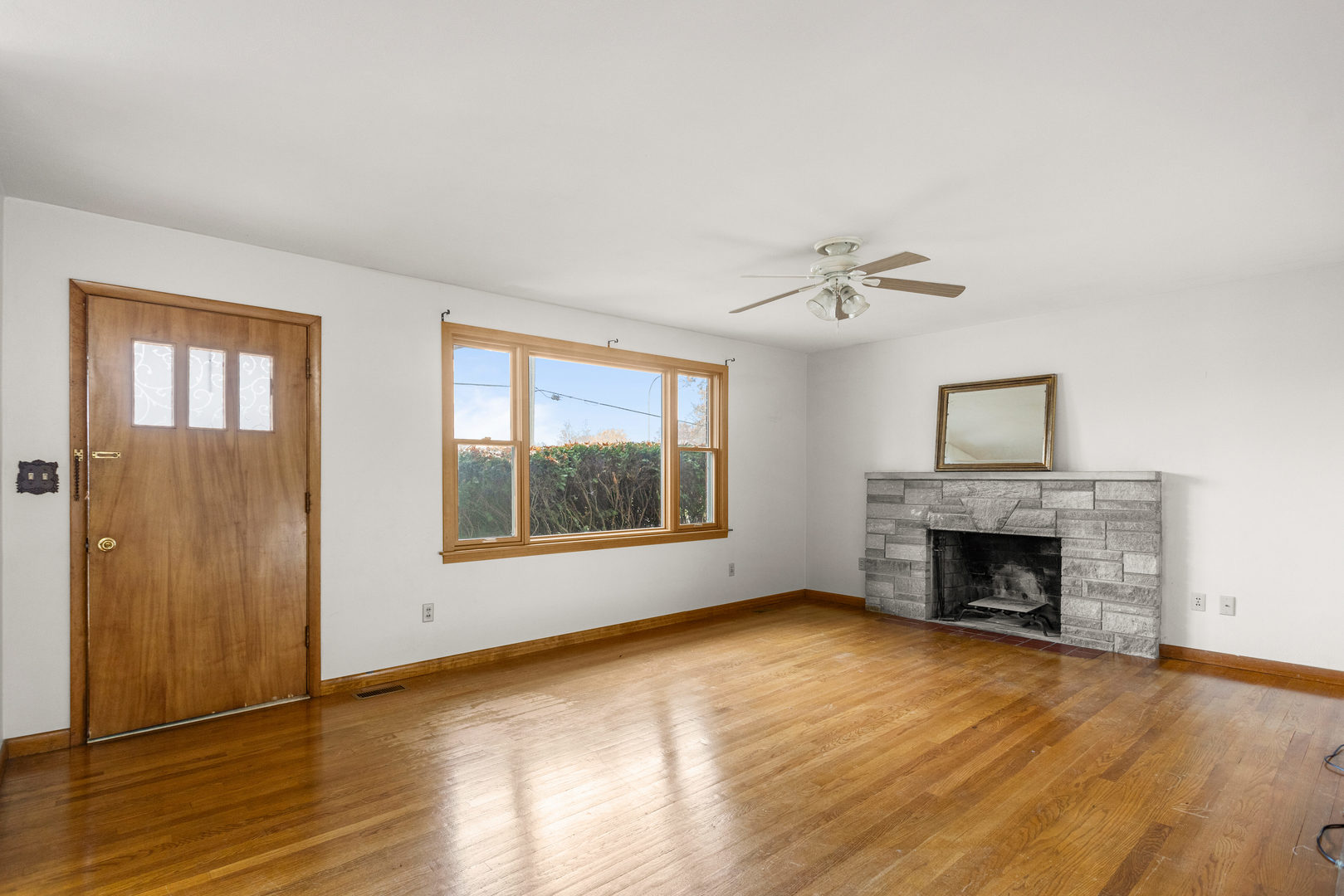 904 West Kirby Avenue Champaign, IL 61821 - Photo 7 of 46 an empty room with wooden floor fireplace and windows