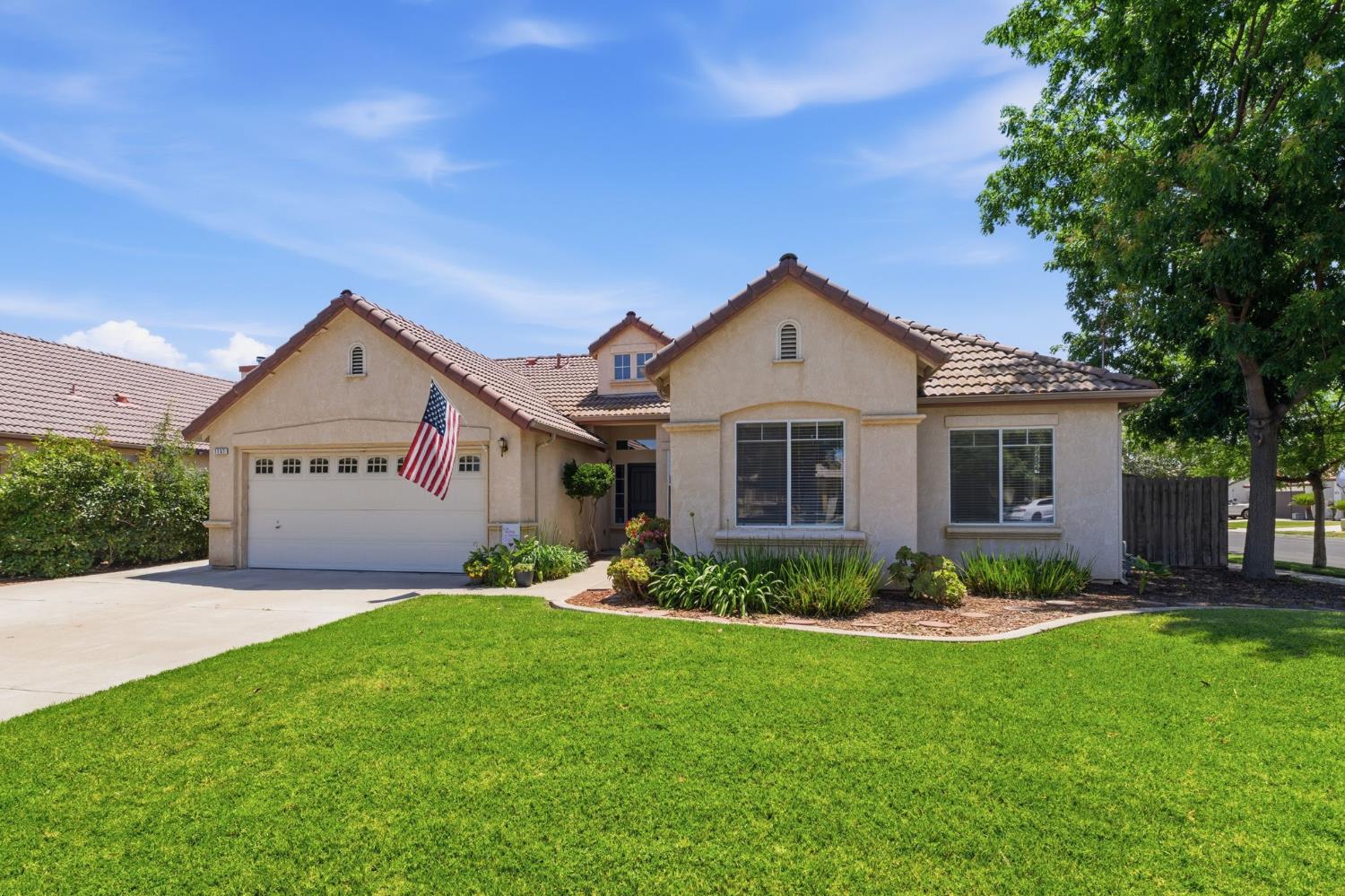1757 Homestead Way Lemoore, CA 93245 - Photo 2 of 35 a front view of house with yard and green space