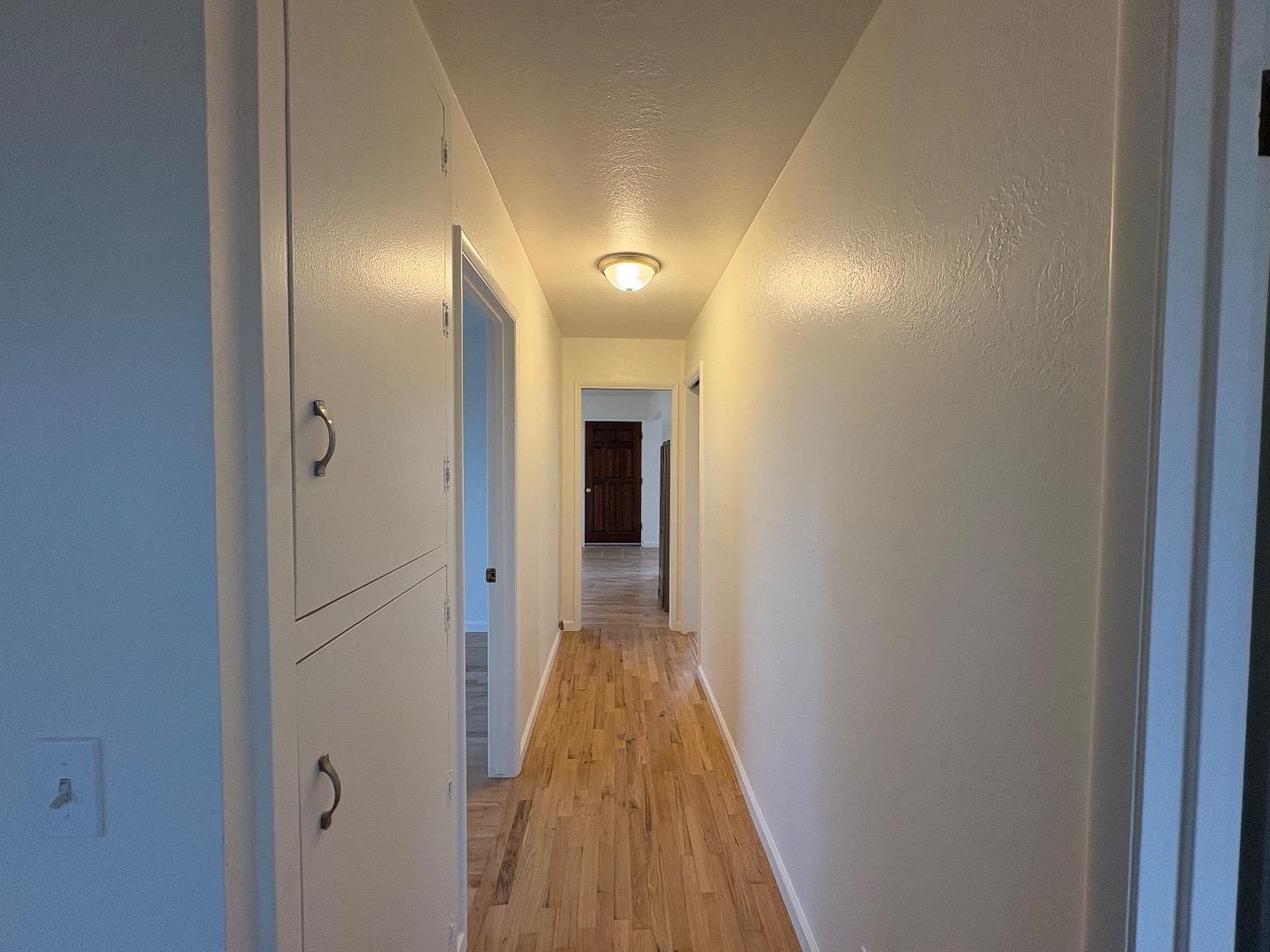 1675 Luxton Street Seaside, CA 93955 - Photo 17 of 33 a view of a hallway with wooden floor