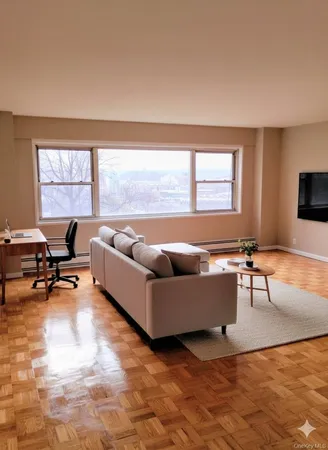 a living room with furniture and a large window