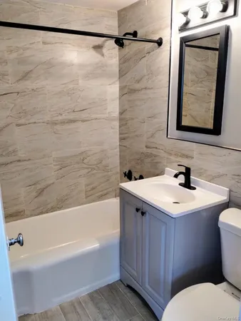 a bathroom with a sink mirror vanity and toilet