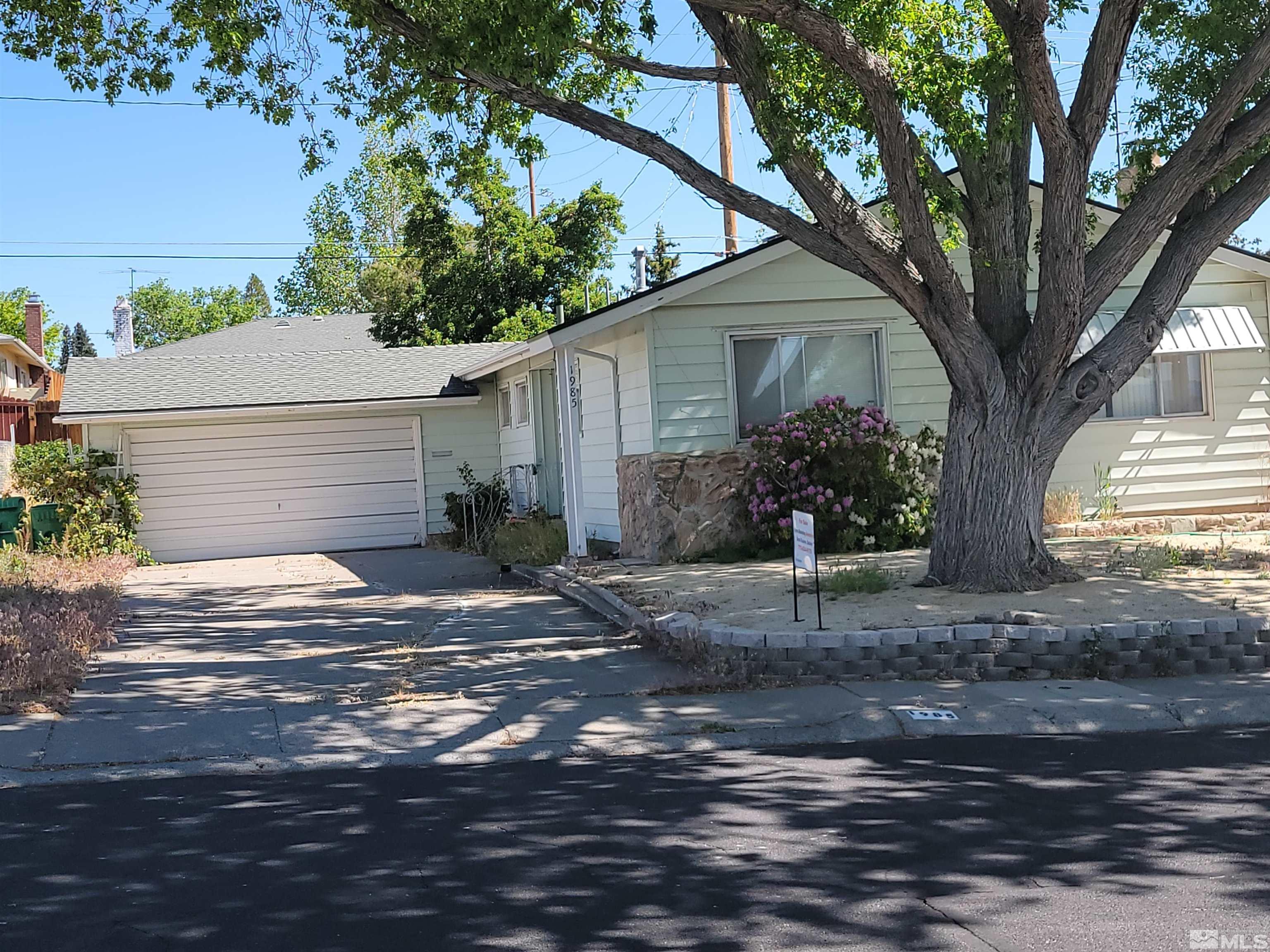 1985 Gridley Avenue Reno, NV 89503 - Photo 1 of 29 a view of a yard in front of a house with large tree