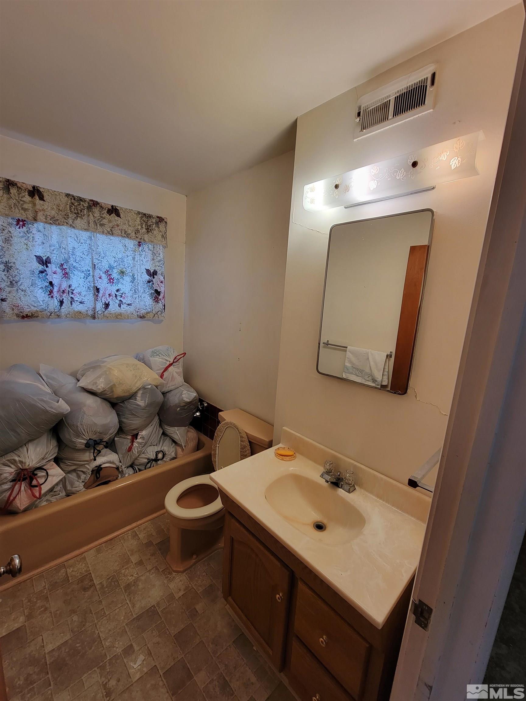 1985 Gridley Avenue Reno, NV 89503 - Photo 16 of 29 a bathroom with a sink mirror and toilet