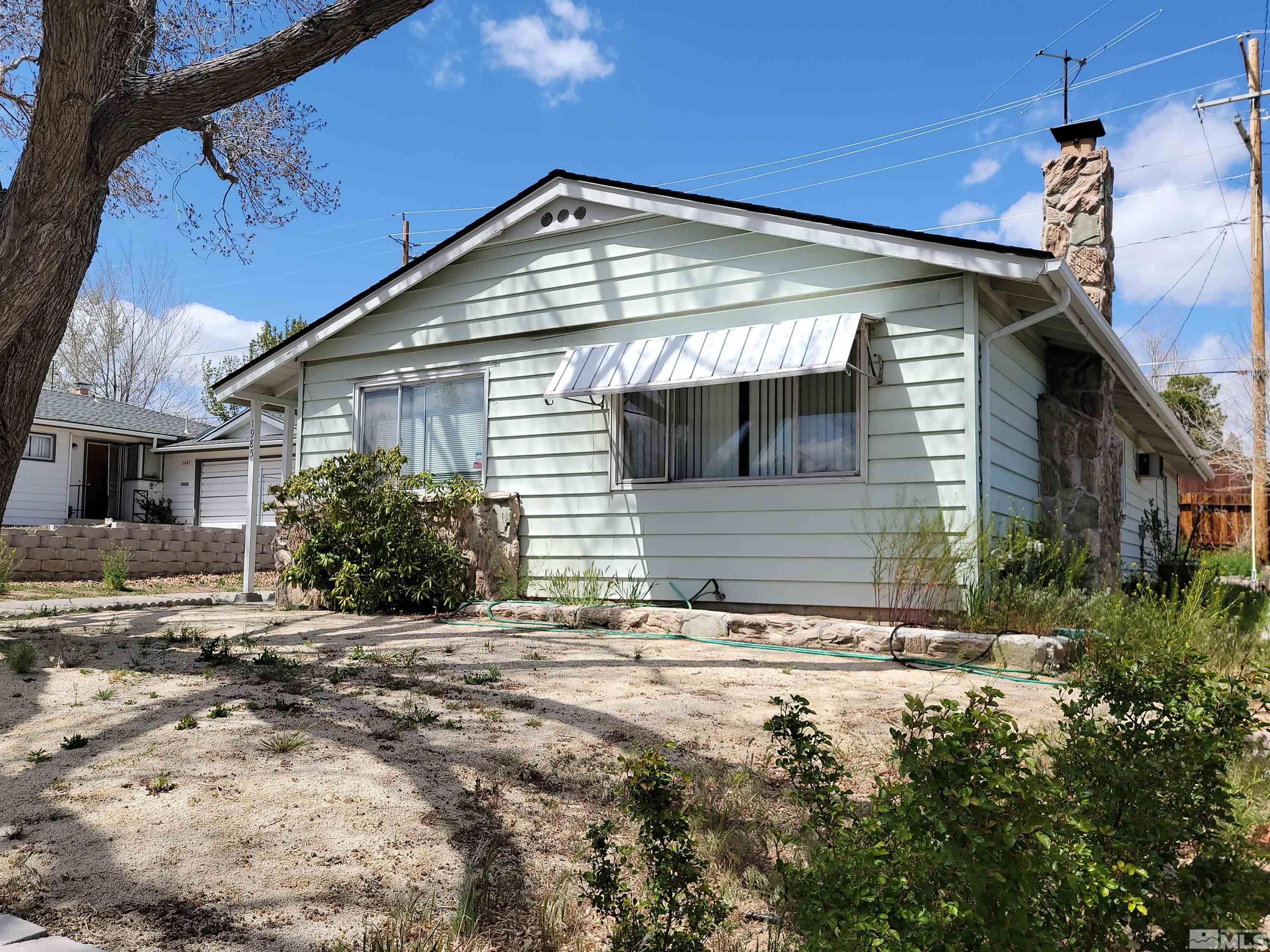 1985 Gridley Avenue Reno, NV 89503 - Photo 2 of 29 a front view of a house with a yard