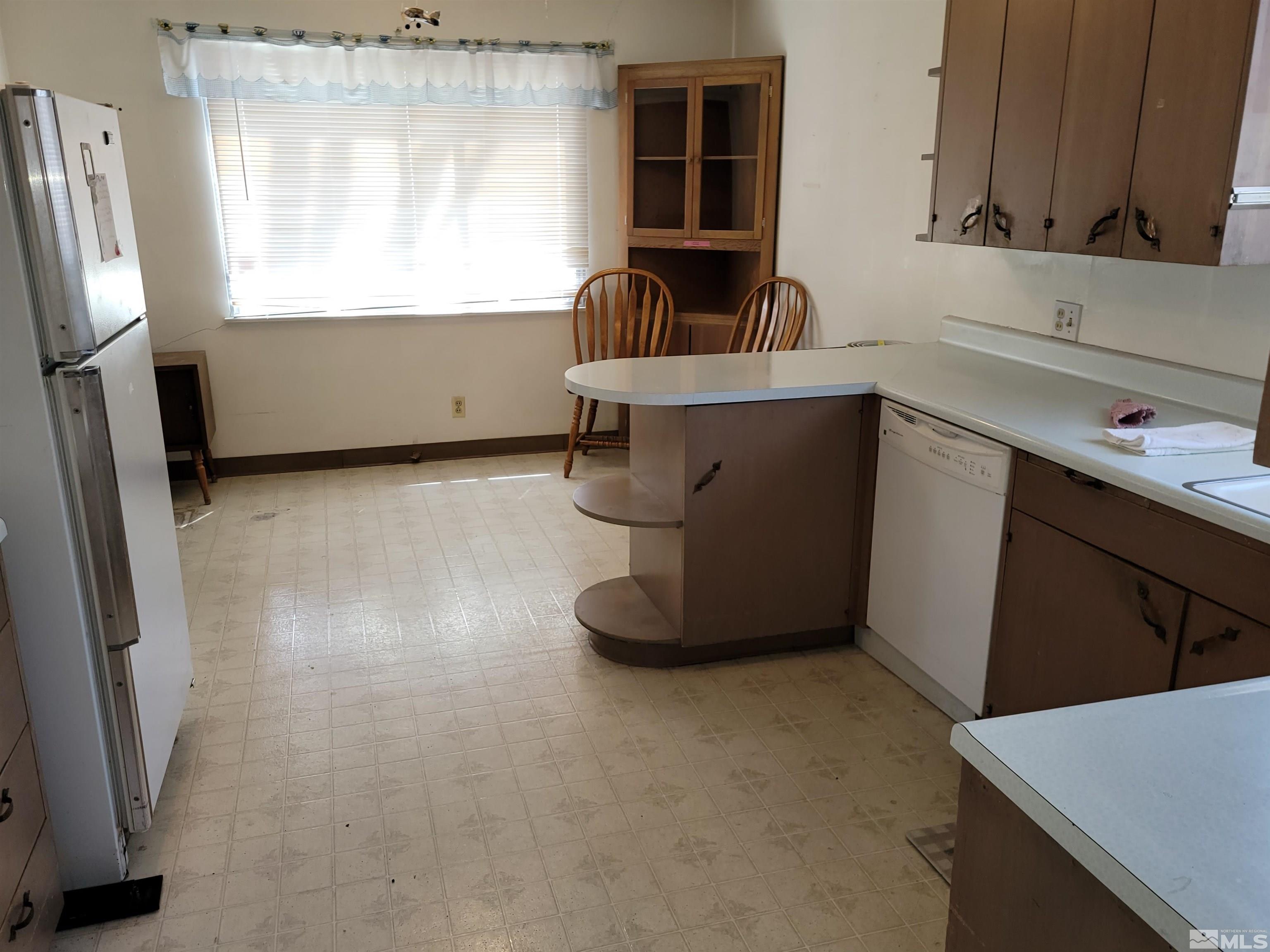 1985 Gridley Avenue Reno, NV 89503 - Photo 6 of 29 a kitchen with a sink a window and cabinets