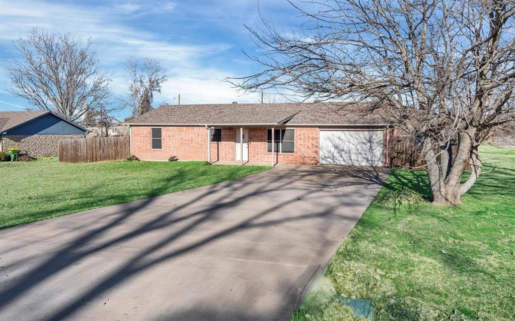 513 Ranch Road Granbury, TX 76049 - Photo 1 of 9 a front view of a house with a yard and a garage