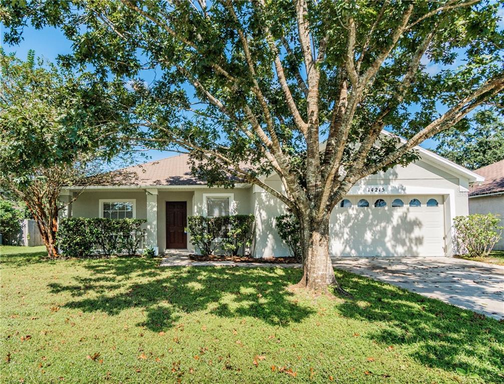 14215 Rensselaer Road Orlando, FL 32826 - Photo 1 of 1 a front view of house with yard and green space