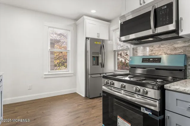 a kitchen with a stove and a microwave
