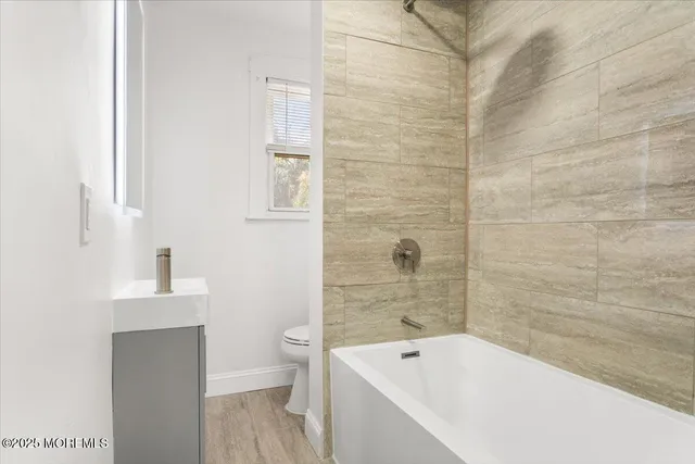 a bathroom with a bathtub and toilet