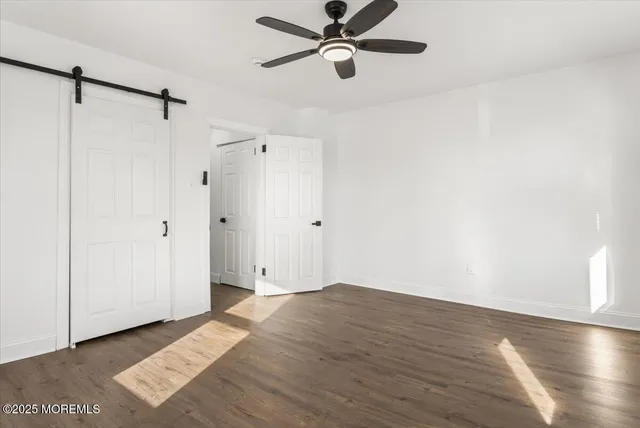 a view of a room with wooden floor and white walls