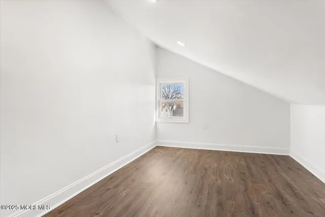 a view of room with wooden floor and window