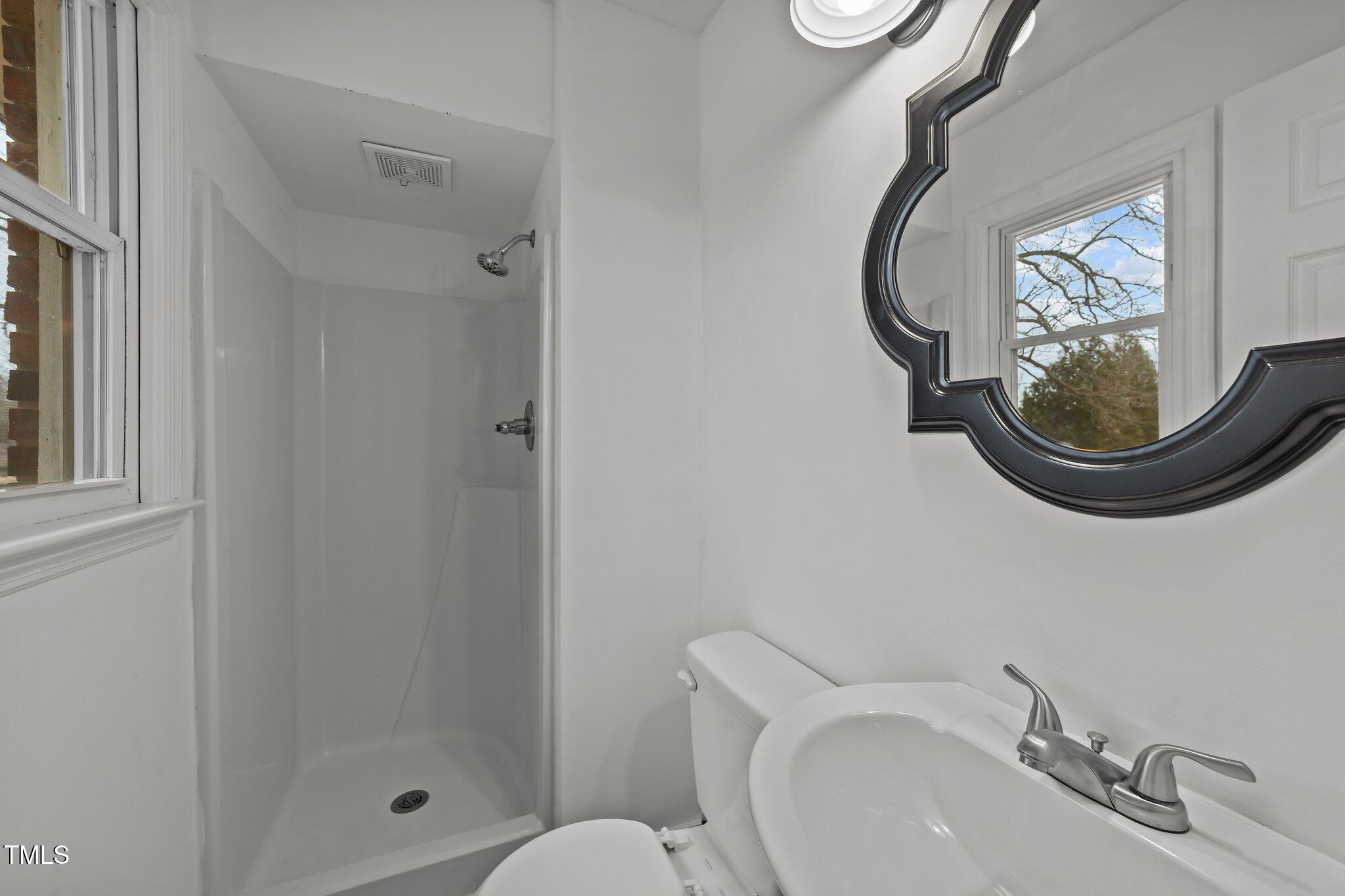 593 Bailey Road Coats, NC 27521 - Photo 25 of 38 a bathroom with a sink and a mirror