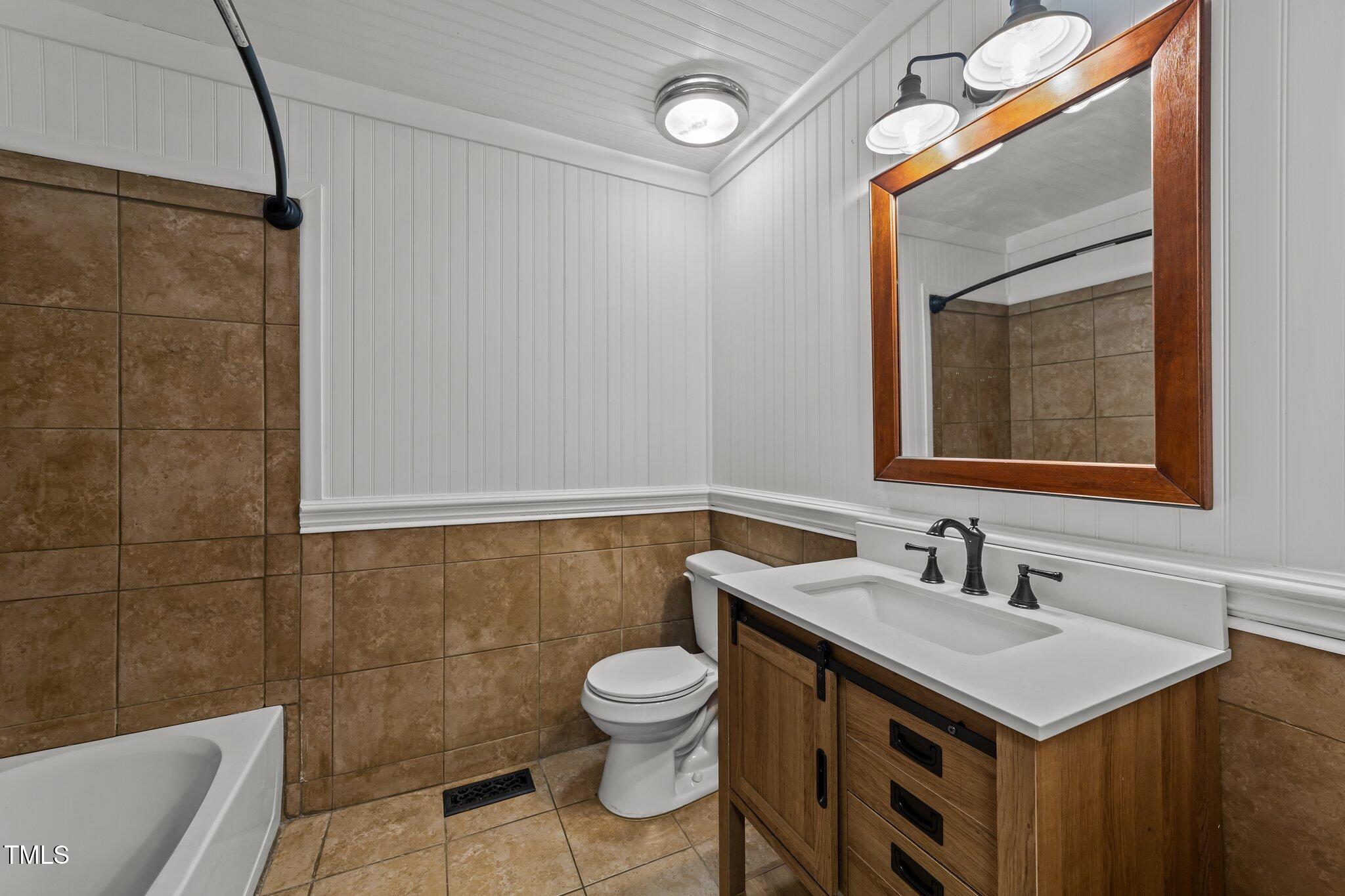 593 Bailey Road Coats, NC 27521 - Photo 26 of 38 a bathroom with a sink mirror and toilet