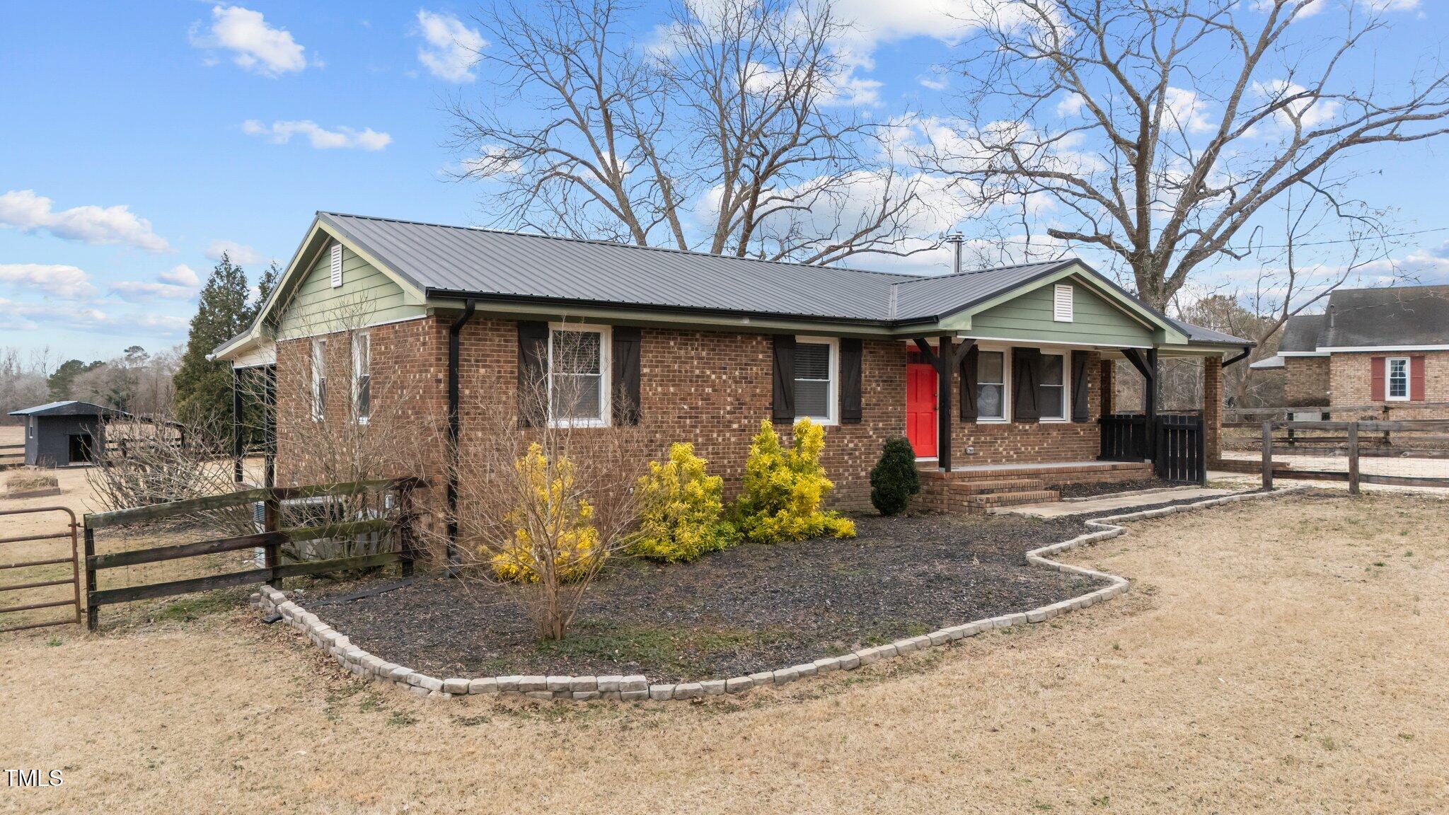 593 Bailey Road Coats, NC 27521 - Photo 2 of 38 a front view of a house with garden