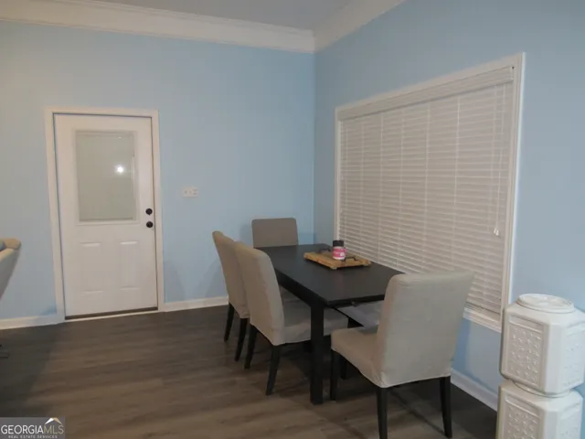 a view of a room with furniture and wooden floor