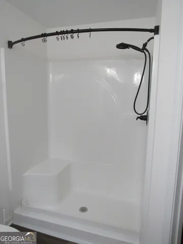 a bathroom with a granite countertop sink vanity and mirror