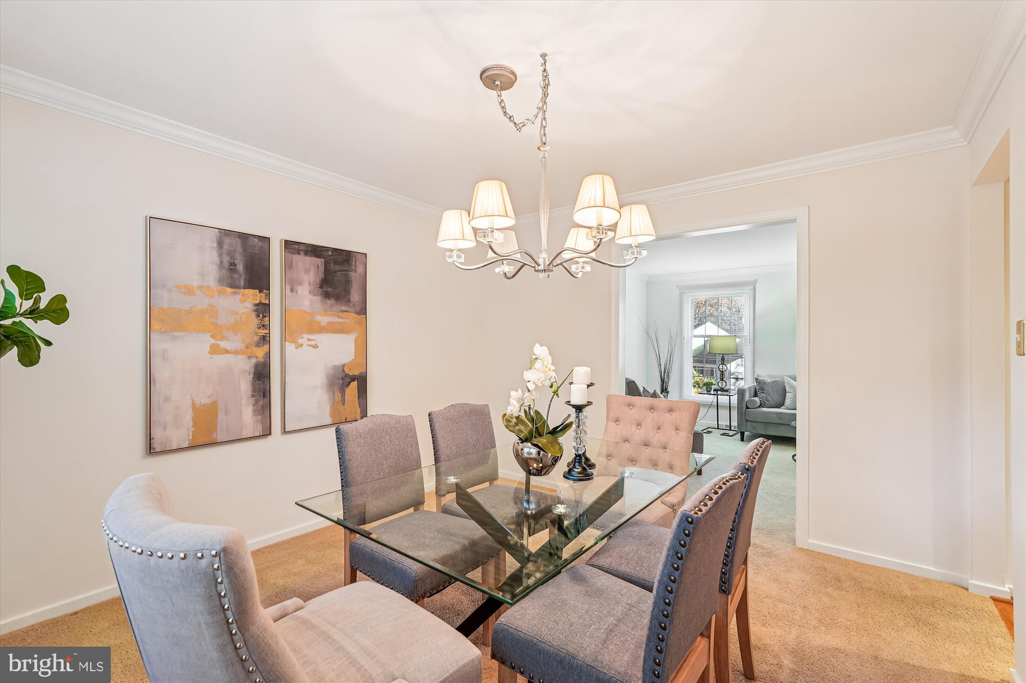 11410 Running Cedar Road Reston, VA 20191 - Photo 11 of 56 a dining room with wooden floor a chandelier a wooden table and chairs